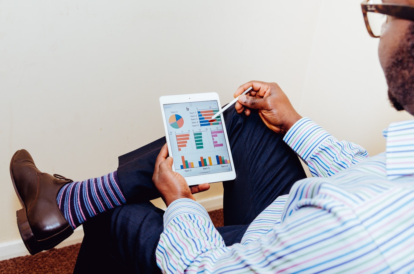 Man looking at tablet with graphs