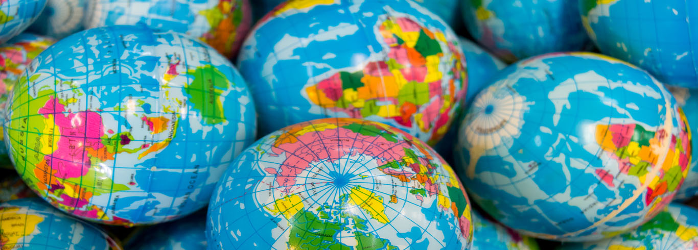 Multiple globes showing different countries in different parts of the world. 