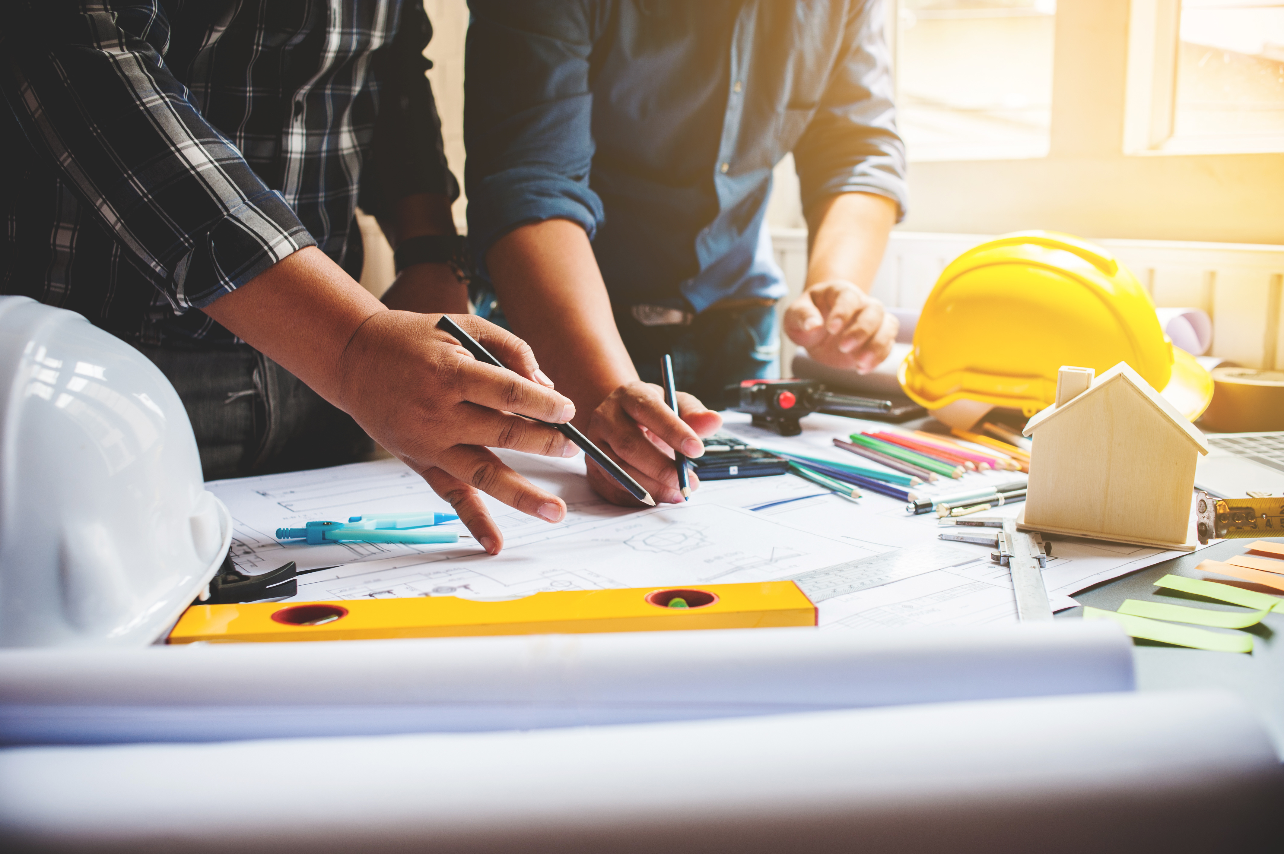 image of people working on an architectural and engineering plan