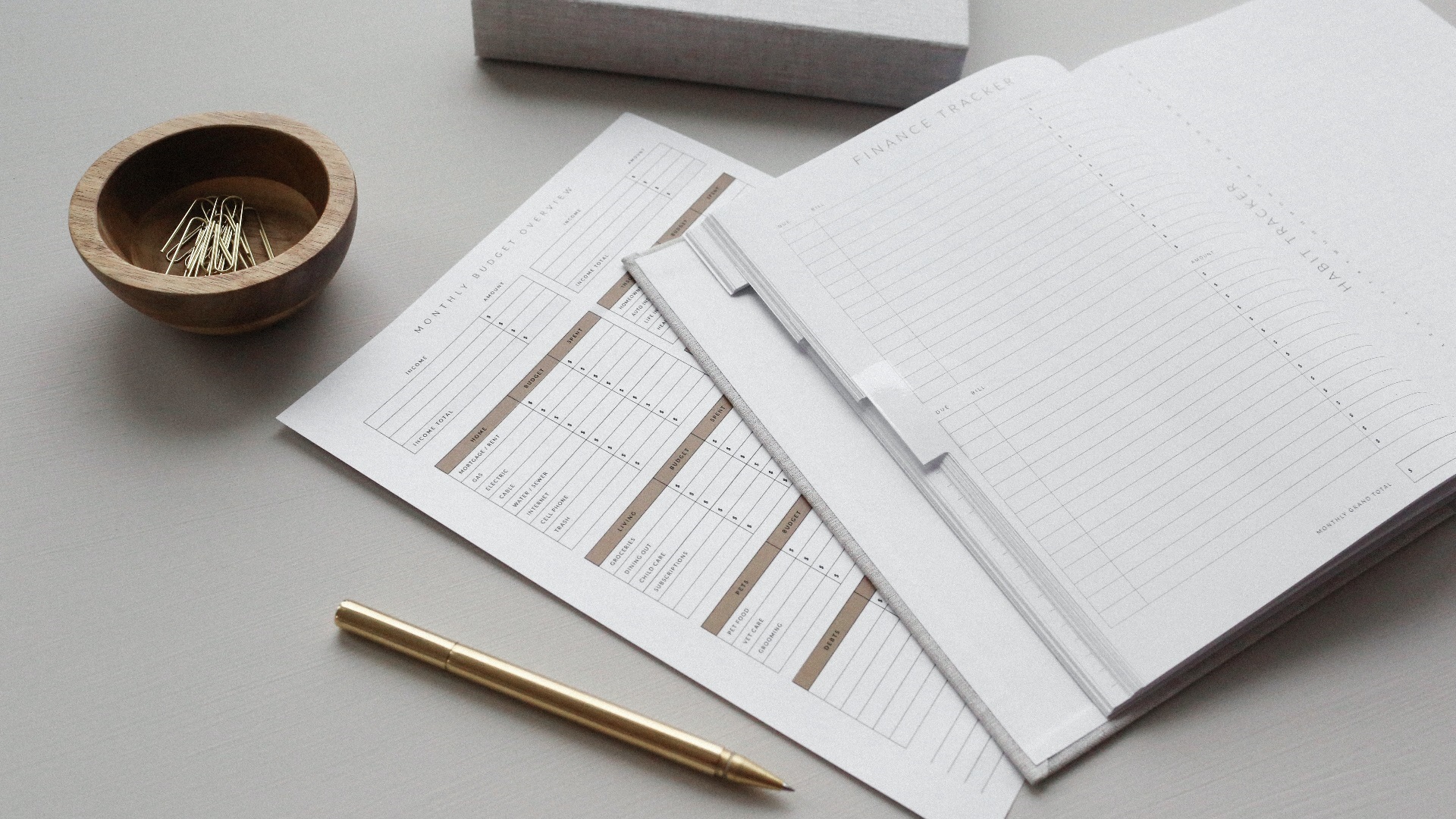 Tax documents on table with pencil and paperclips.