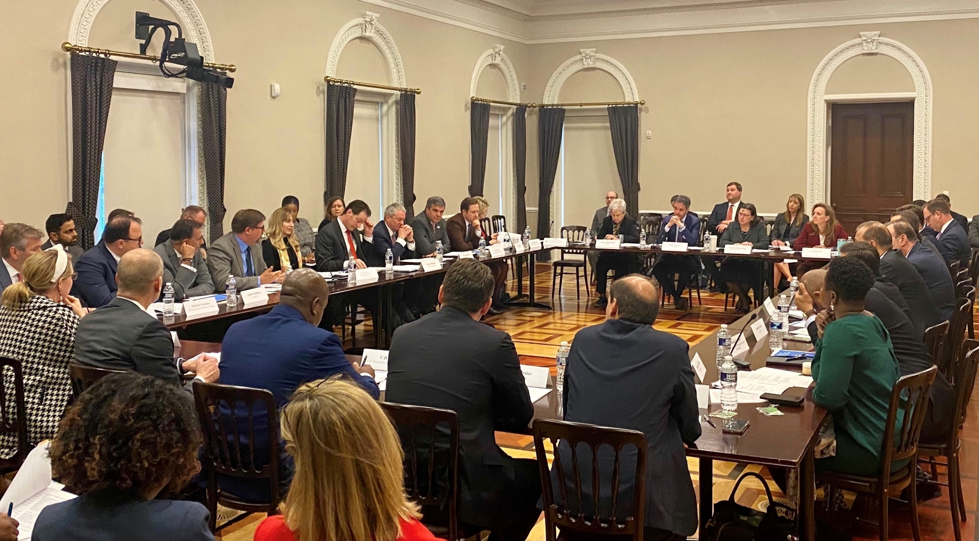 PAC-DBIA Members and US Government officials around a rectangular table