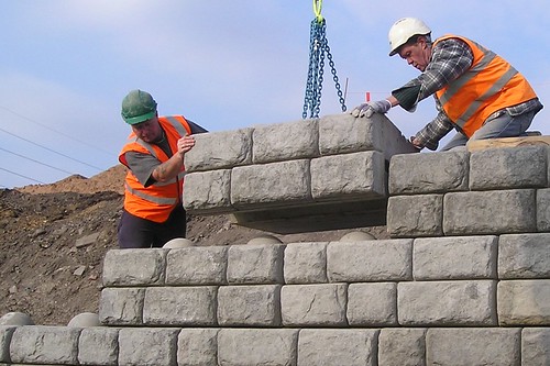 Excavator's set blocks into place