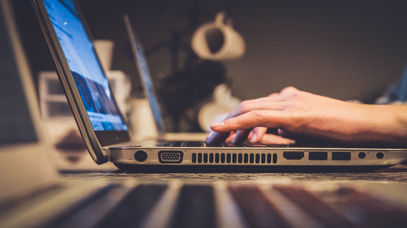 Image of a person sitting at a laptop.