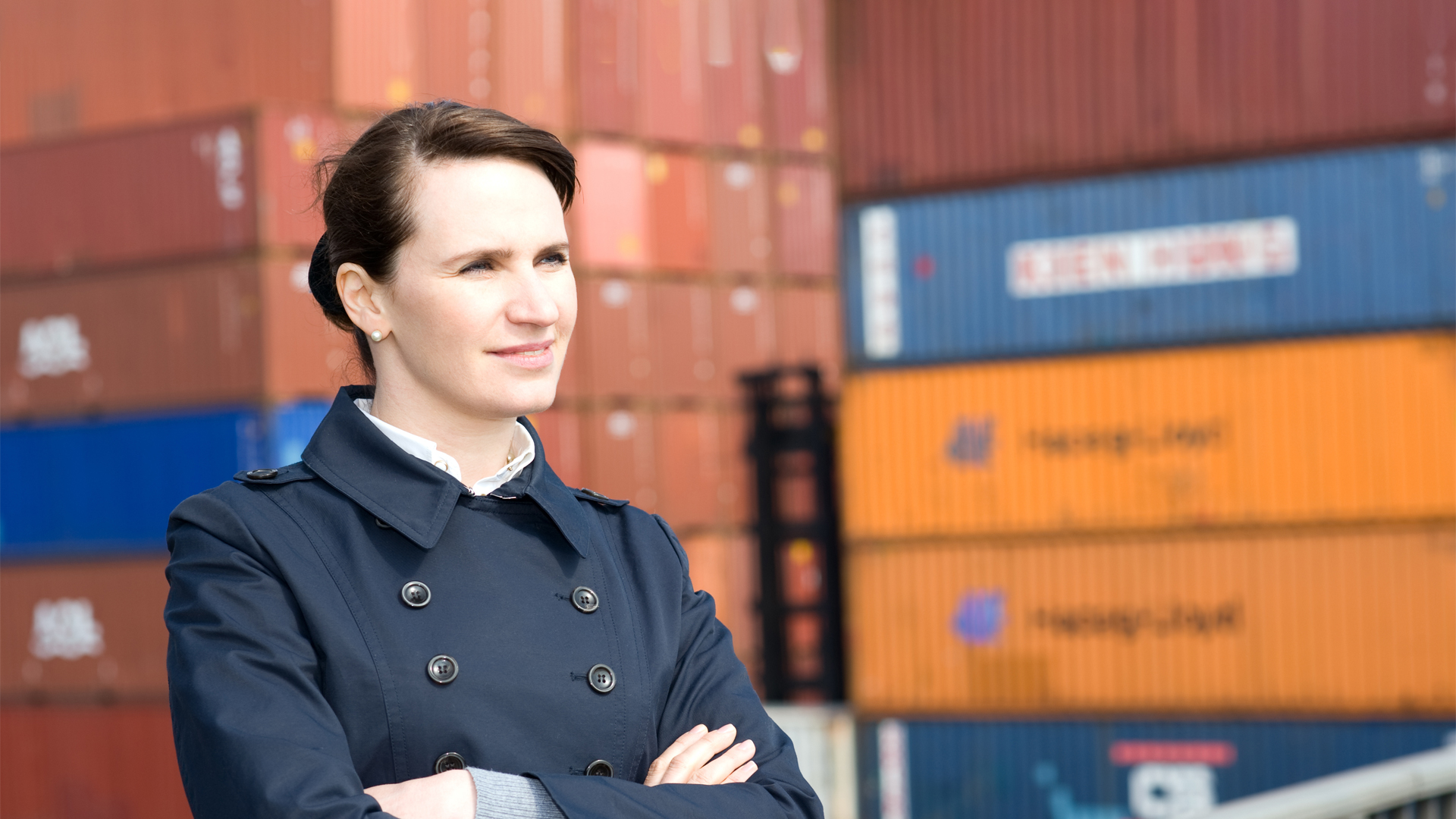 Business woman portrait near cargo containers in a ship yard