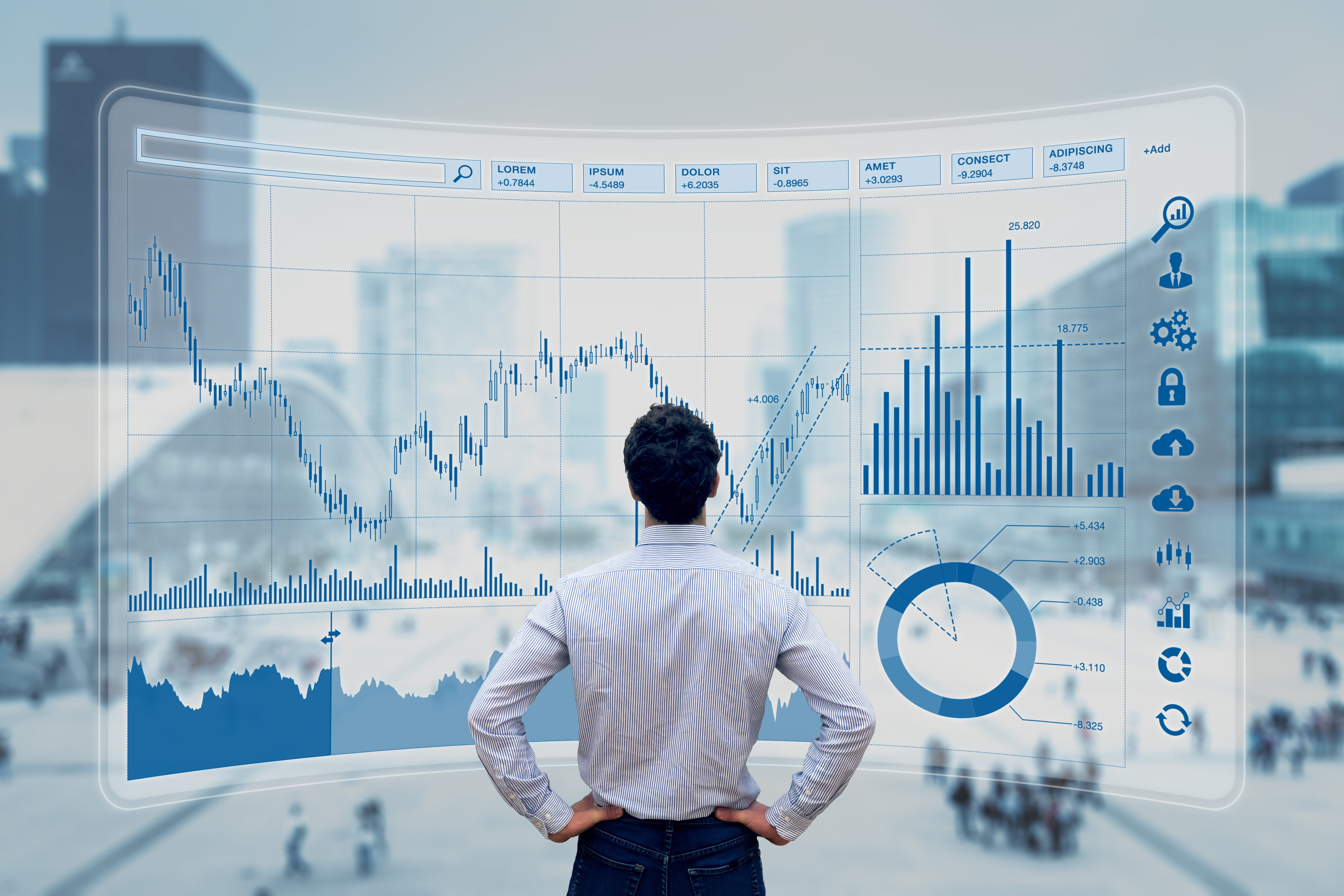 Man standing in front of a wall of various data charts