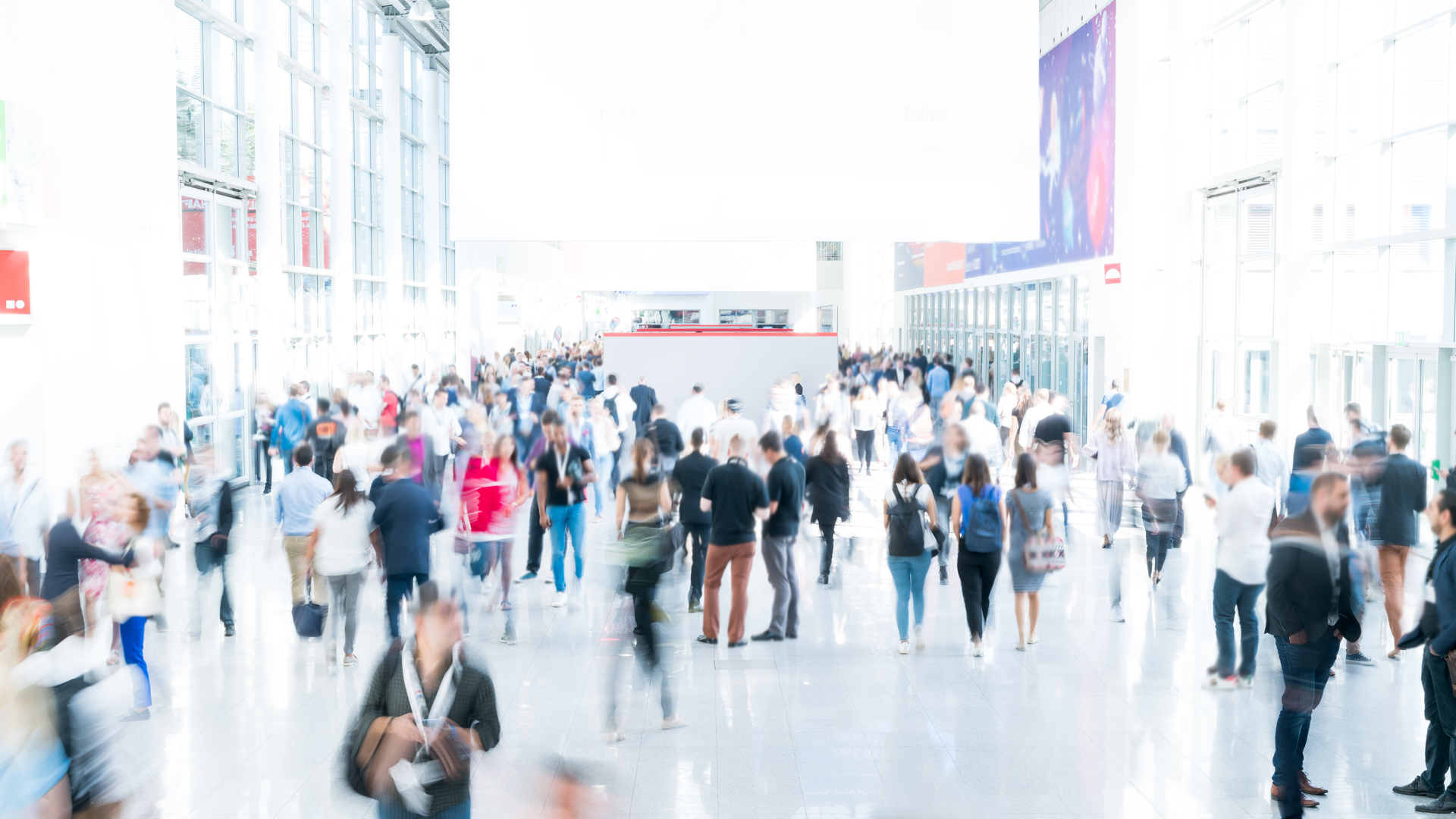 Blurred people at a trade fair with high light exposure image