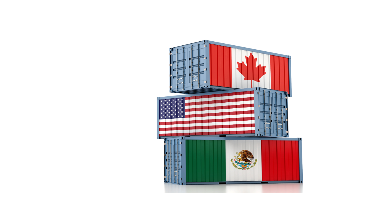 three cargo containers stacked atop each other with us, Canadian, and Mexican flags