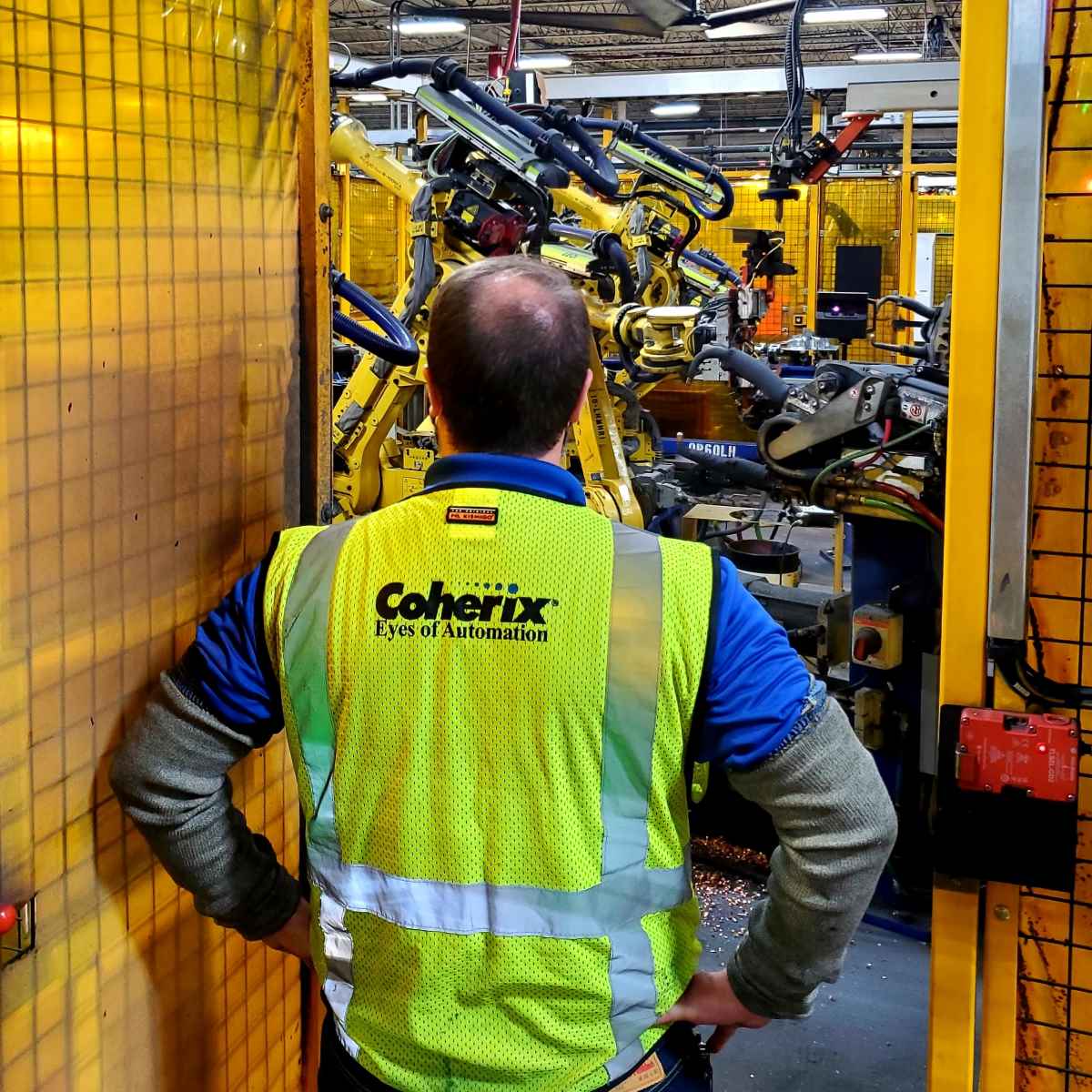 Coherix Worker Examines Factory