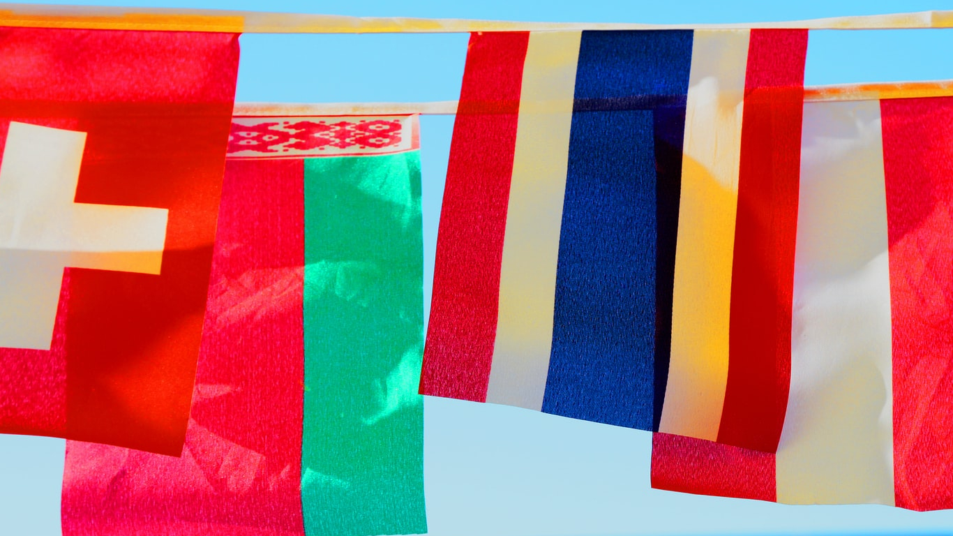 Image of international flags hanging from a line.