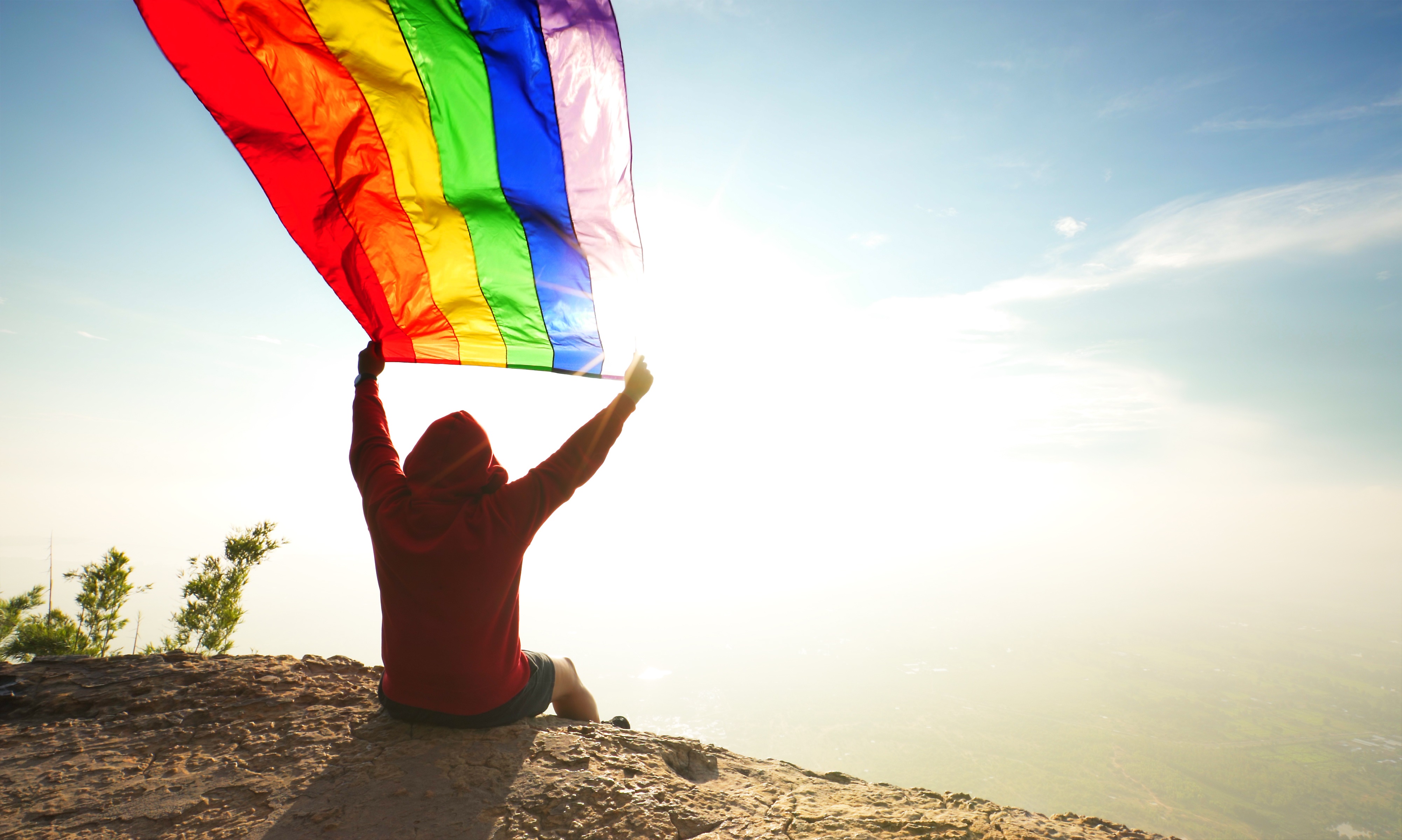 man with a Flying LGBT flag