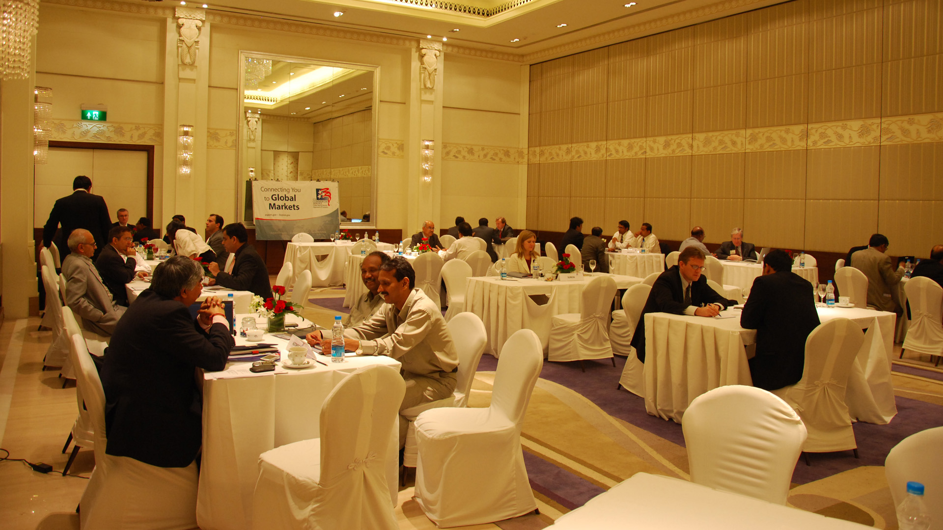 Solar Trade Mission conference in a Hotel conference room with people sitting at white tables 