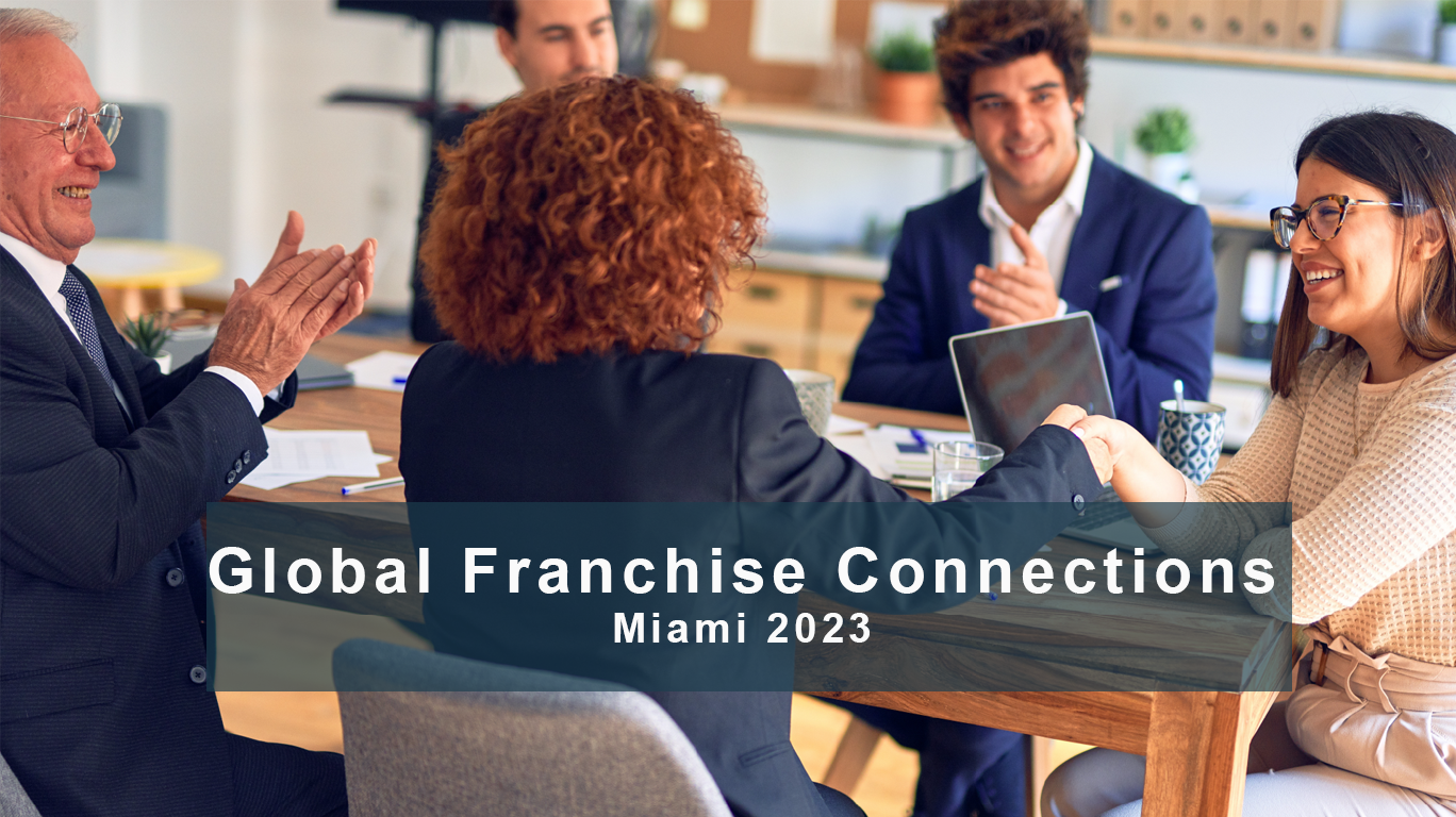 Diverse people sitting at a table with two women shaking hands with text: Global Franchise Connections, Miami 2023