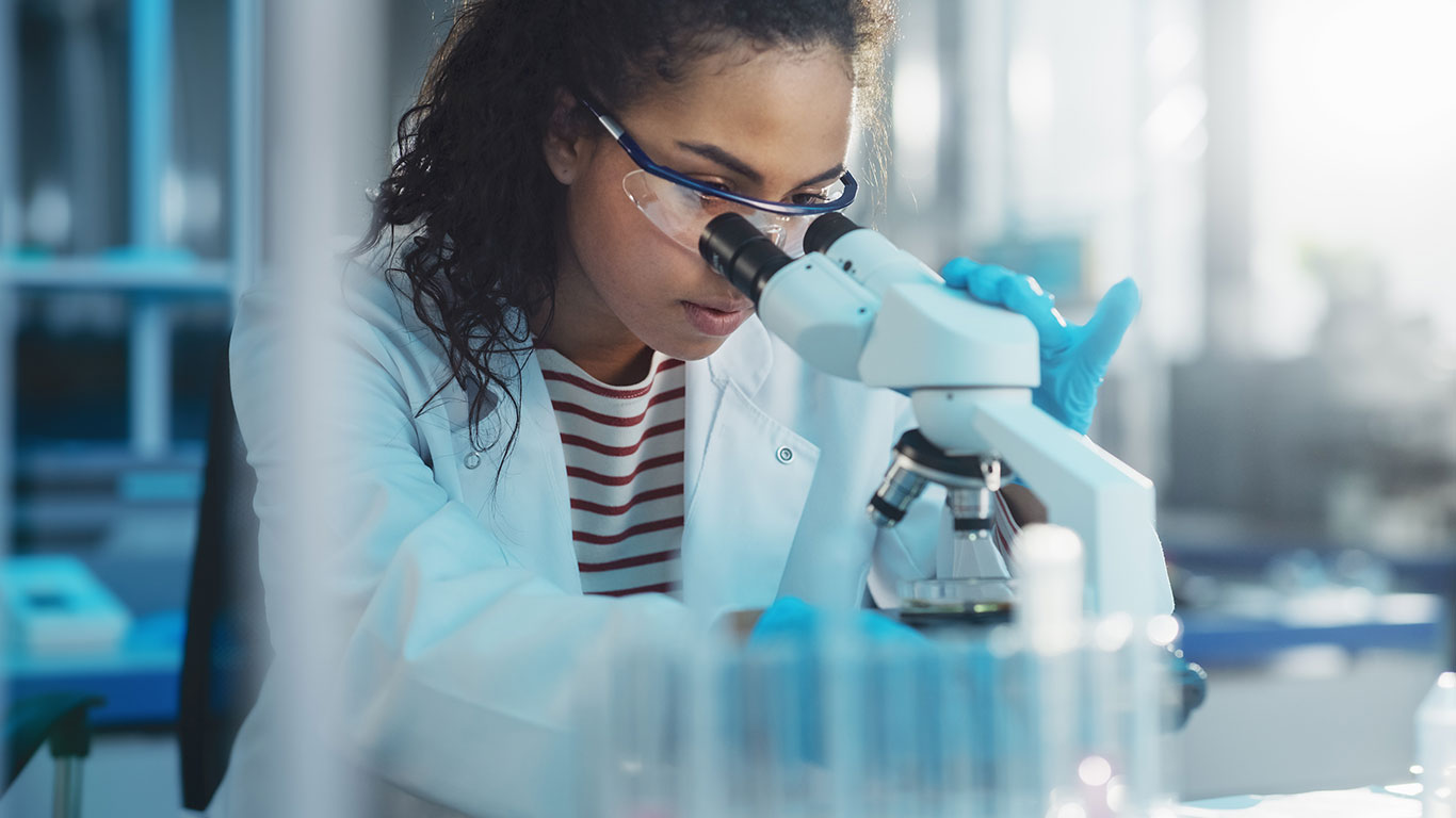 Woman looking into a microscope