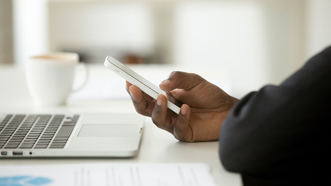 Person at computer using phone