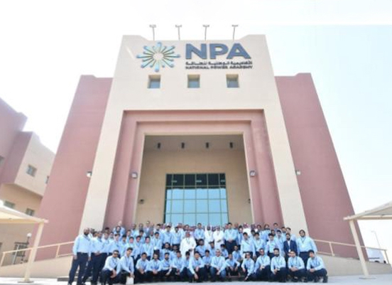 A large group of children outside a building with a sign on it that says NPA