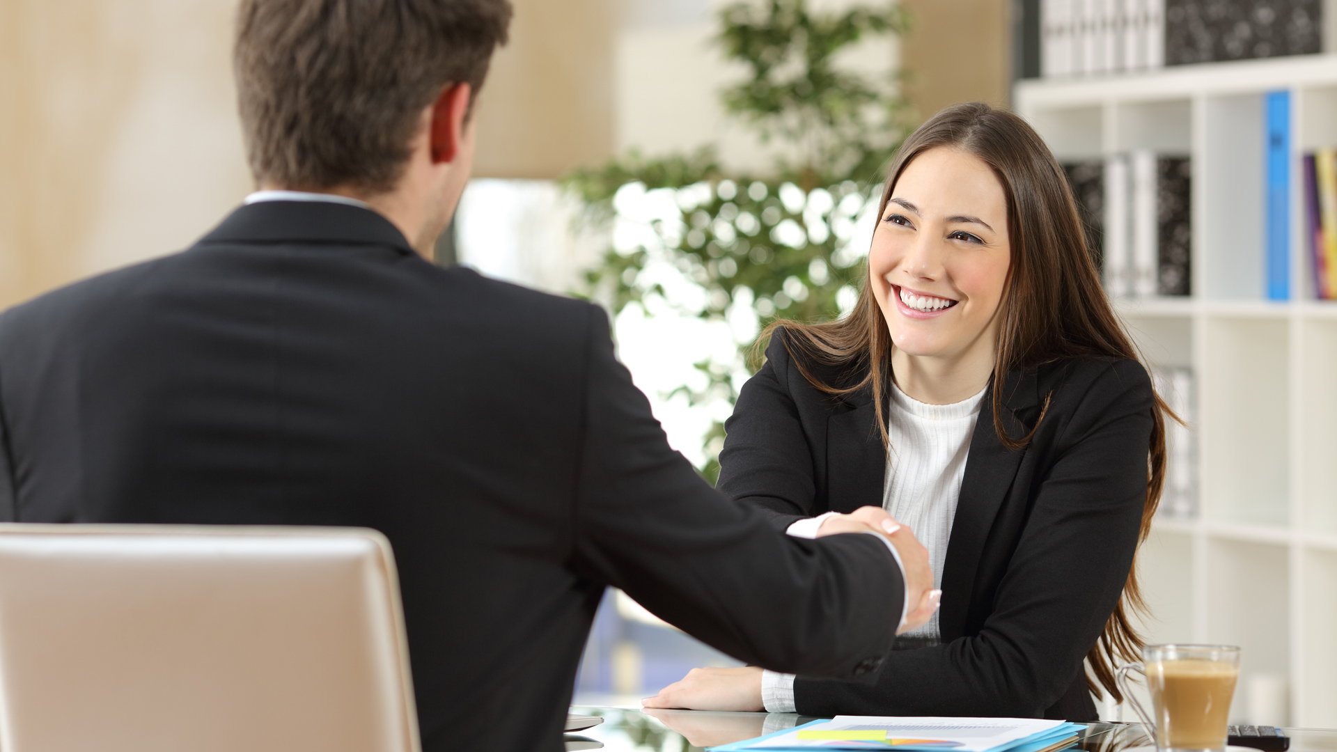 business man and woman shaking hands after negotiation in a office