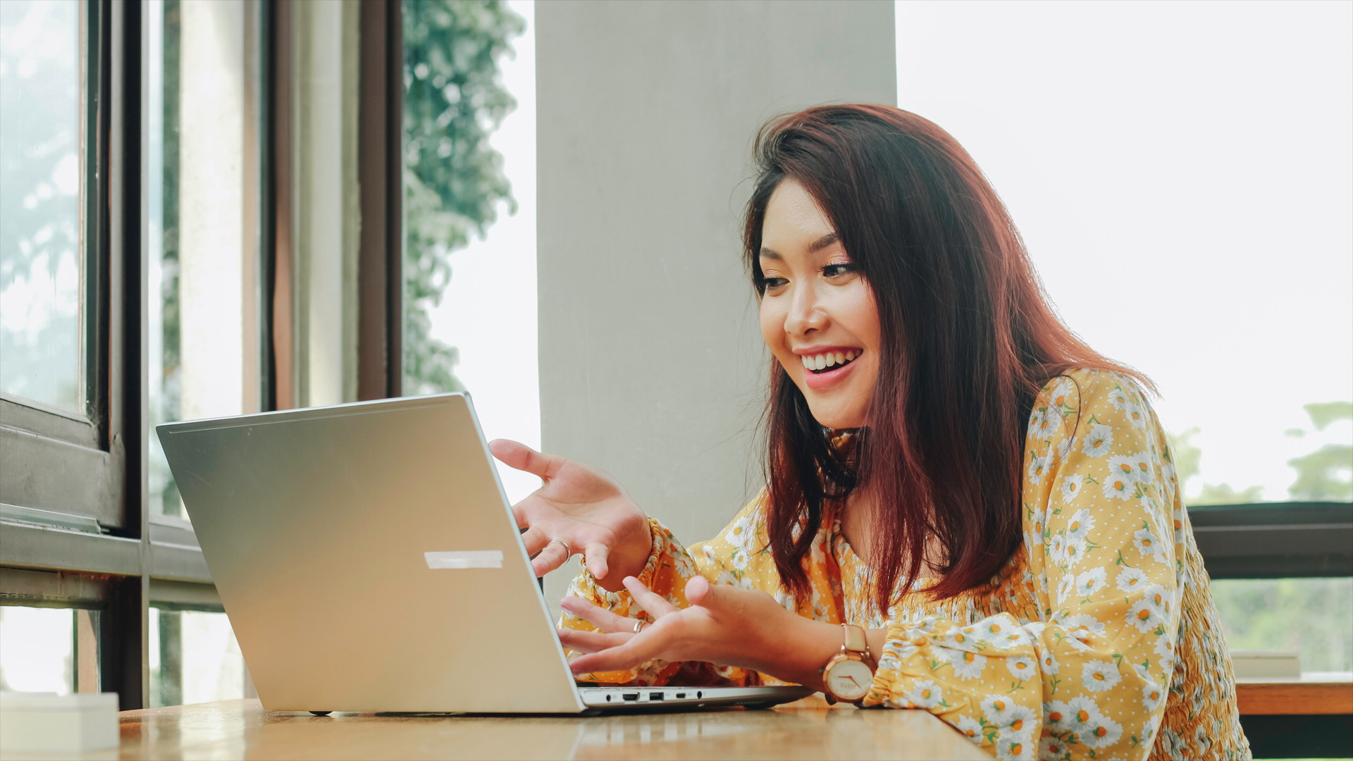 Young Asian woman doing video conference on laptop computer while sitting at the cafe, having meeting Image