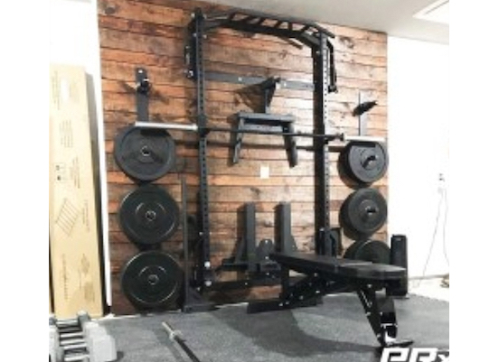 Black weight equipment hanging on a dark wood wall
