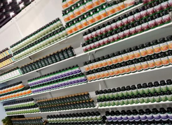 Shelves of different colored bottles in a store