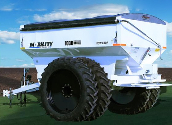 A picture of a very large farming device with large black wheels