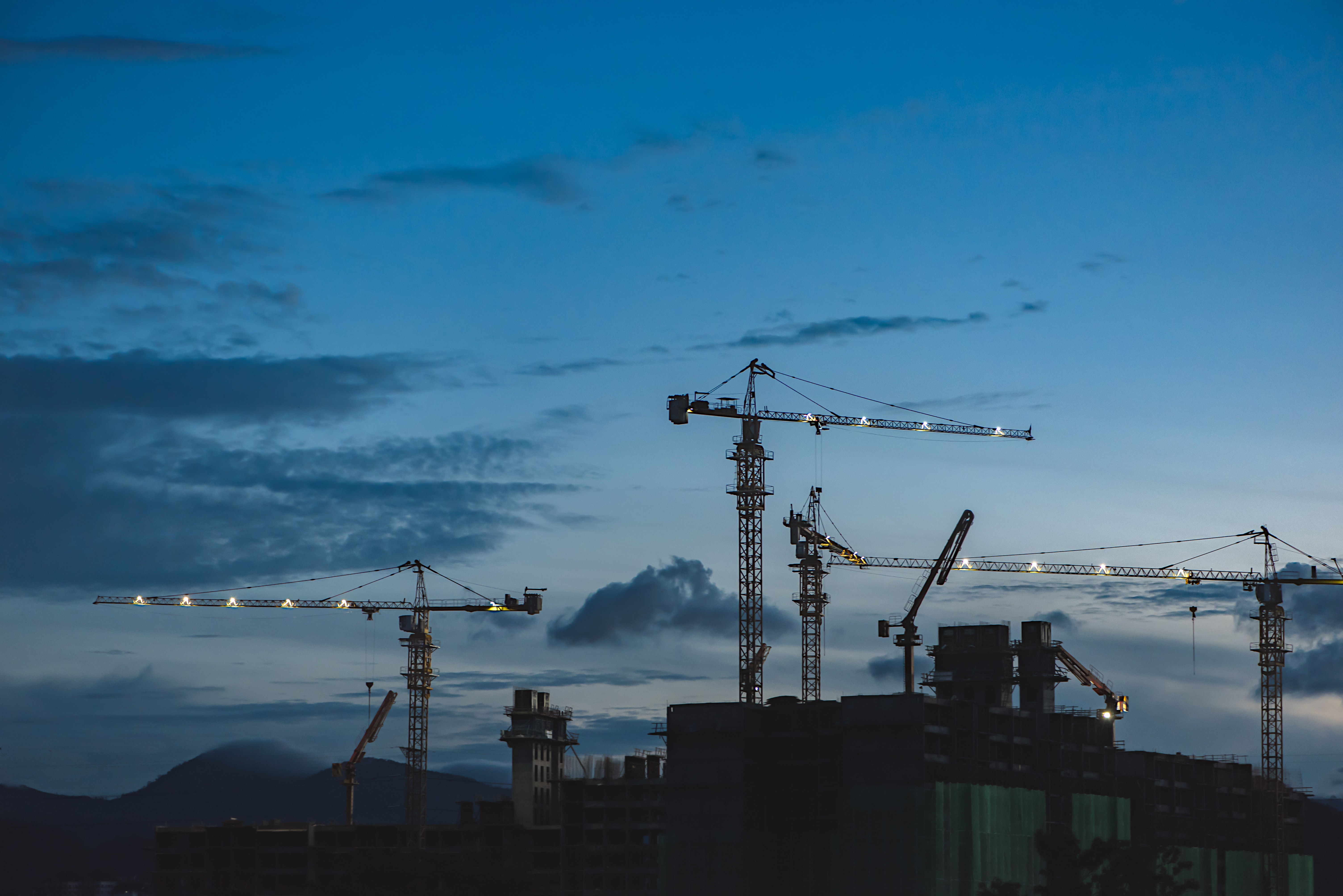 Construction site with cranes at dusk