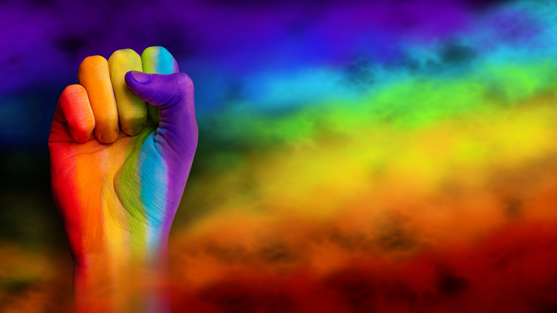 Gay pride concept. Hand drawn with a rainbow behind. Gay pride LGBT rainbow flag. Fist symbol LGBT Image