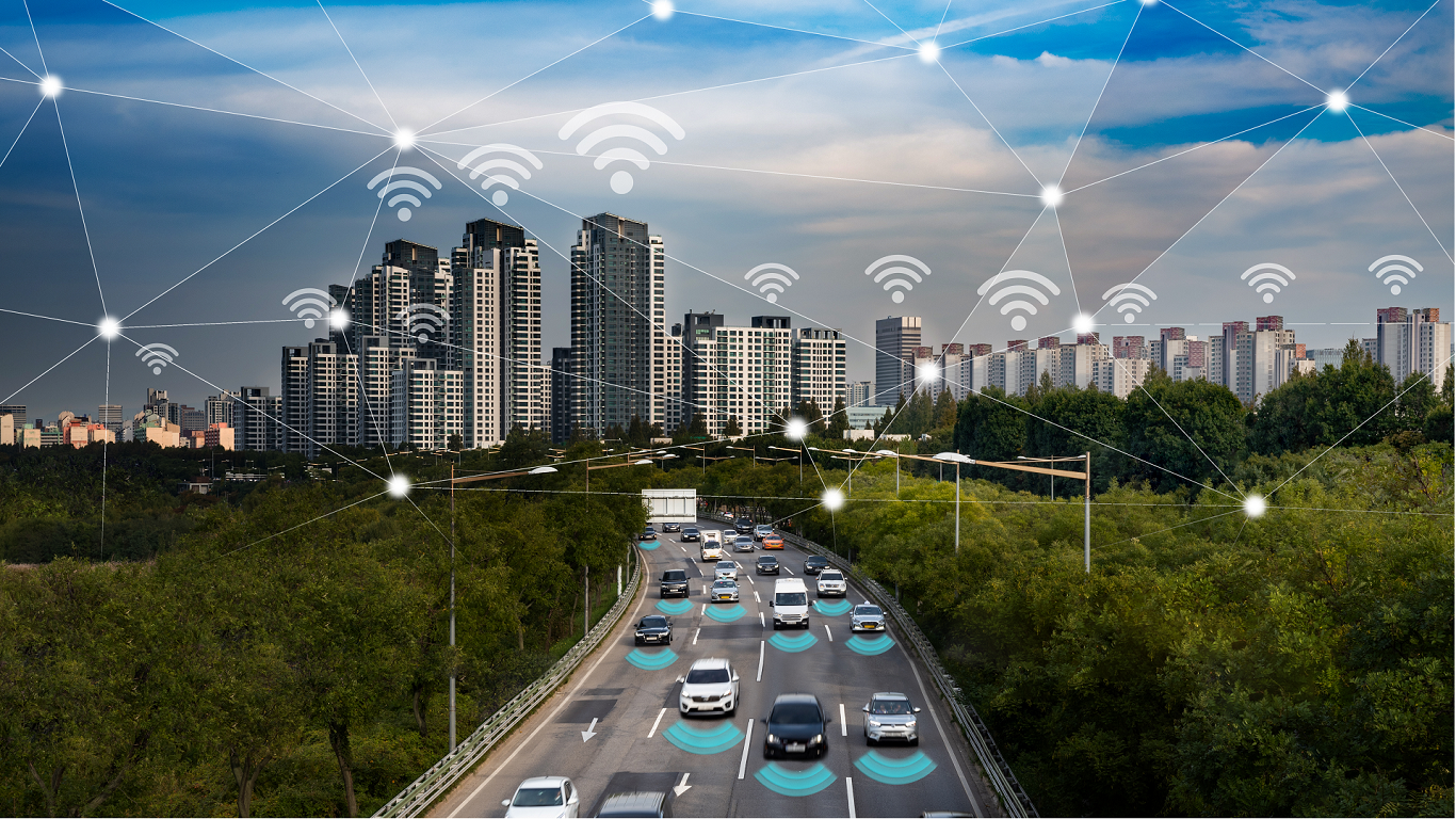 Cars on city highway with internet symbols above cars and buildings