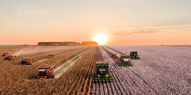 industrial agriculture fields being plowed with tractors