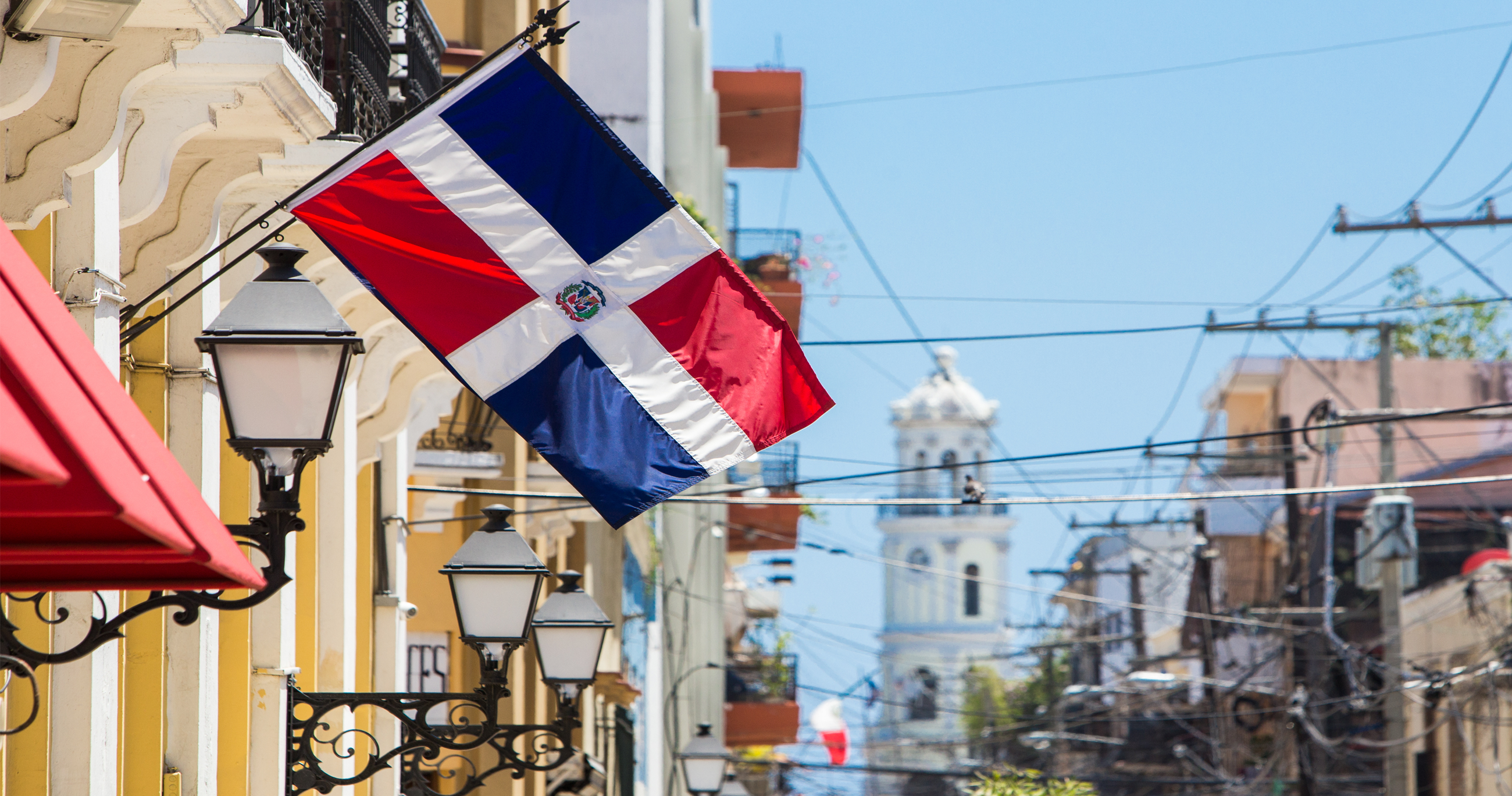 Dominican Republic flag with Santo Domingo in background