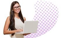 A photograph of a smiling young woman entrepreneur and her laptop.