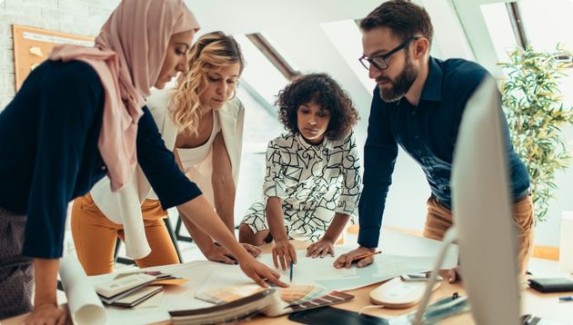 A photograph of business people scrutinizing a sales contract.