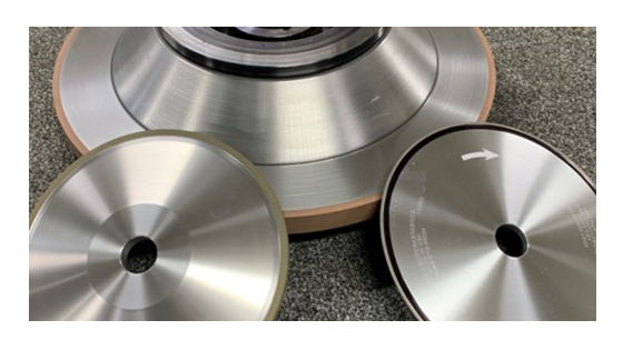 Three silver grinding wheels