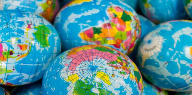Multiple globes showing different countries in different parts of the world.