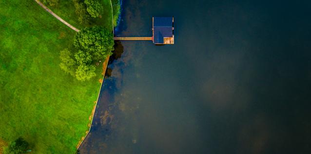 house on water next green grass