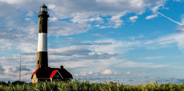 Lighthouse behind green grass