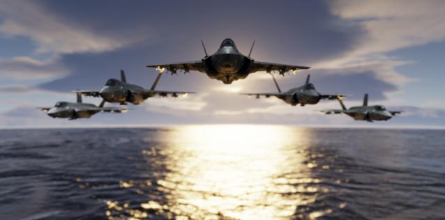 Image of three F-35 jet fighters flying in formation over the ocean at sunset