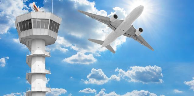 Airplane pass by an air traffic control tower