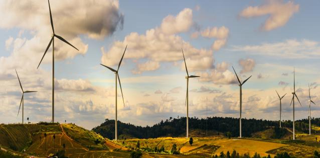 Group of wind turbines among rolling fields