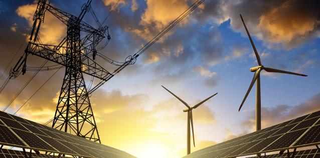 Solar panels with wind turbines and electricity pylon at sunset. Clean energy concept Image