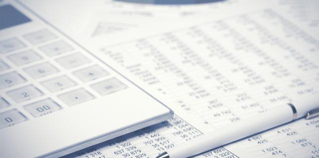 Financial accounting pen and calculator on balance sheets Image