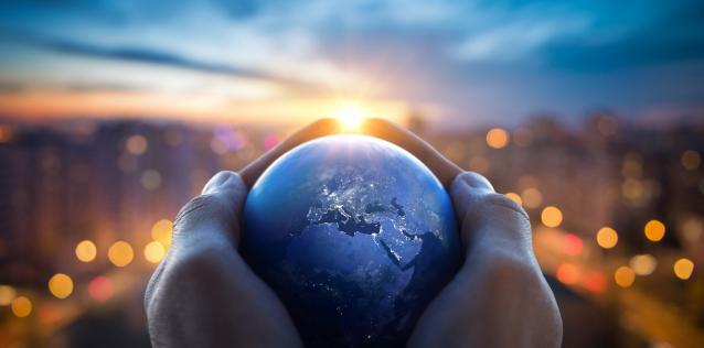 The globe Earth in the hands of man against the night city Image for Hero Box