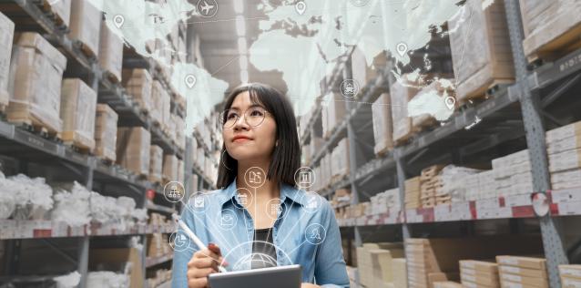 Woman working in a factory with world may overay