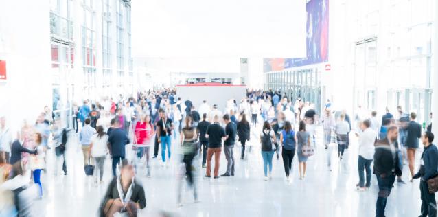 Blurred people at a trade fair with white background image for Hero Box