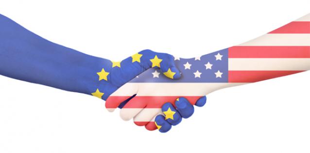 International business to hand shaking with the EU-Europe flag painted on and USA flag painted on hands and arms 