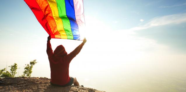 man with a Flying LGBT flag