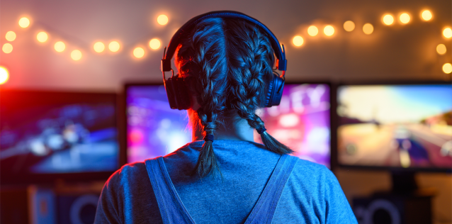 Back of woman with braids playing video games