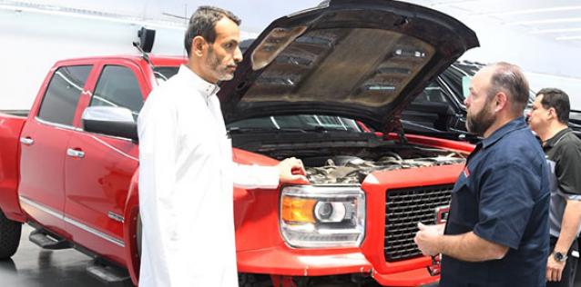 Men talking beside truck with hood up