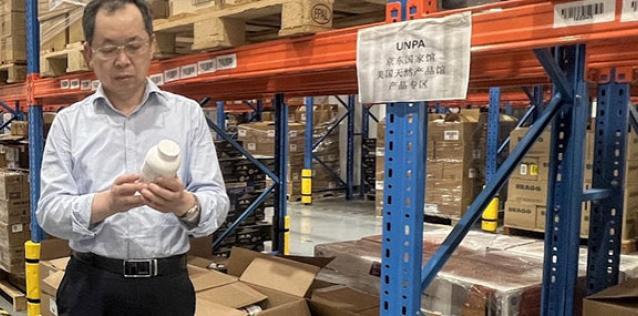 man in warehouse looking at U.S. supplement in China