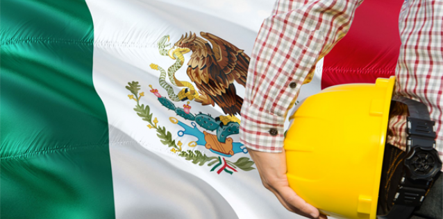 Mexico flag with man holding construction helmut