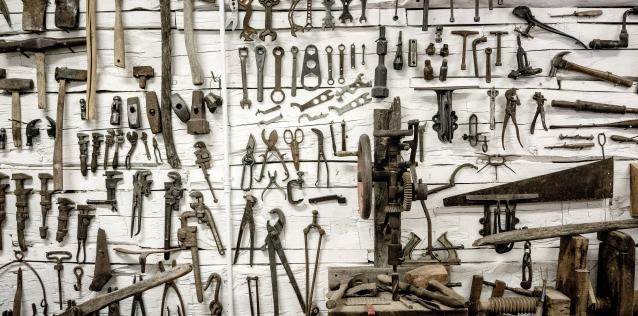 Assortment of construction and home improvement tools hanging on wall